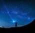 silhouette of man holding flashlight